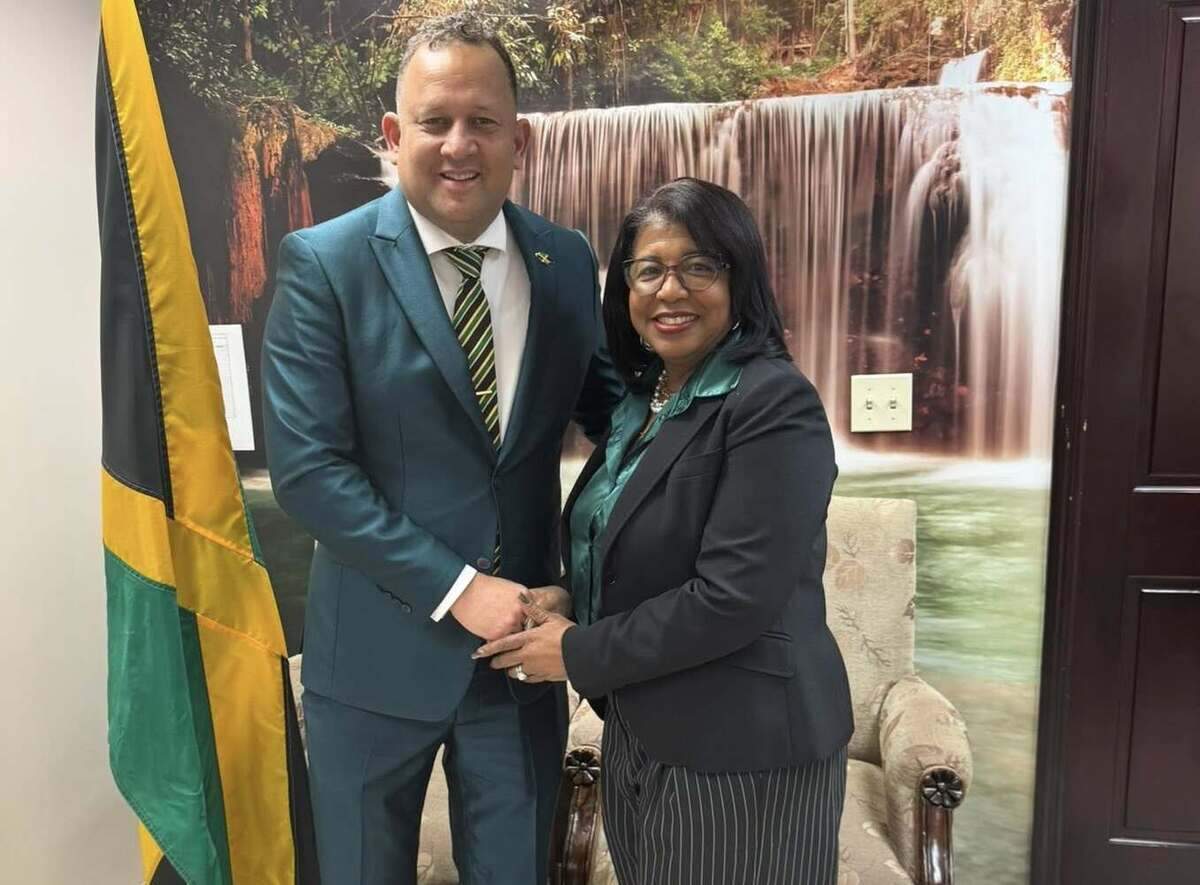 Janice McIntosh, the new Jamaican diaspora leader, is congratulated on her election by Oliver Mair, the Jamaican consul general in Miami.