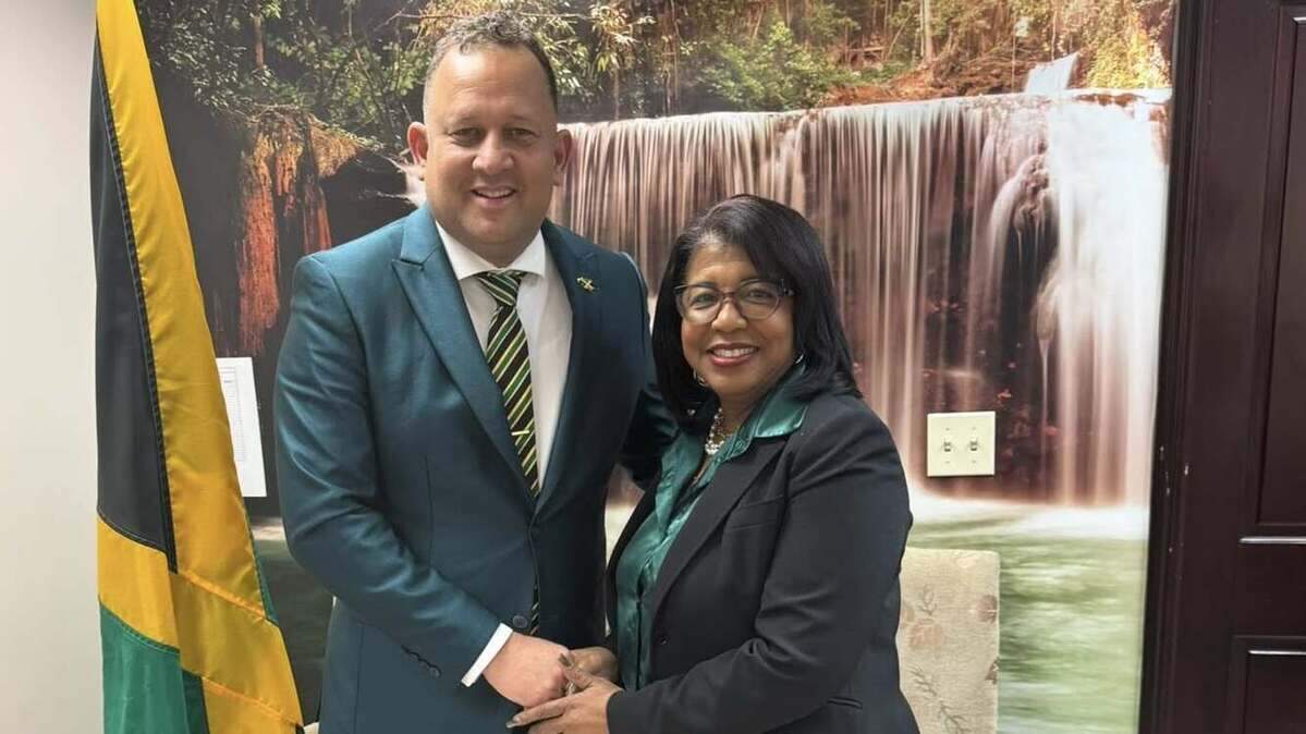 Janice McIntosh, the new Jamaican diaspora leader, is congratulated on her election by Oliver Mair, the Jamaican consul general in Miami.