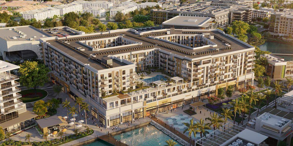 Apartments and retail buffer a 5.5-acre water basin with a fountain feature in Miramar Cove’s design.