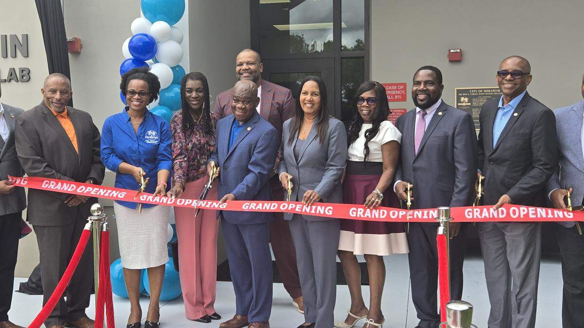 Dr. Roy L. Virgin (center) cuts the ribbon to the West Water Treatment Lab with Broward Commissioner Alexandra P. Davis (left), Miramar Vice Mayor Yvette Colbourne (right) and various city officials and family members.